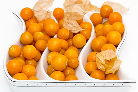 orange physalis fruits in ceramic bowl thumbnail