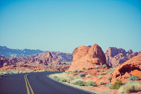 gray asphalt road on desert during daytime thumbnail
