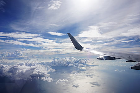 photography of plane wing and clouds thumbnail