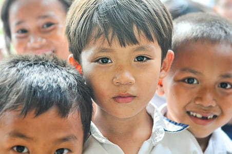 four children in white collared tops posing for a photo thumbnail