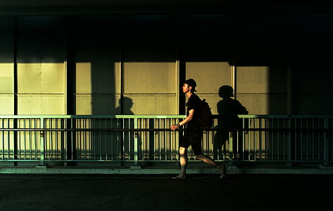 man walking beside rails thumbnail