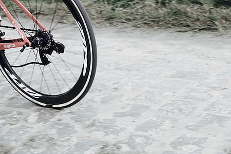 pink bicycle parked on gray concrete road thumbnail