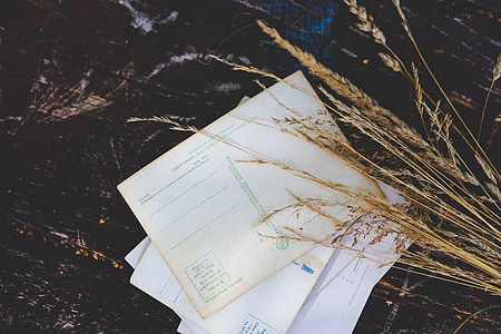 several papers on black wooden surface thumbnail