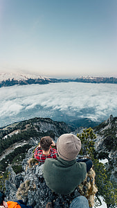 men on mountain summit looking at sea of clouds thumbnail