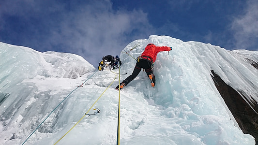 two person climbing mountain filled with snow thumbnail