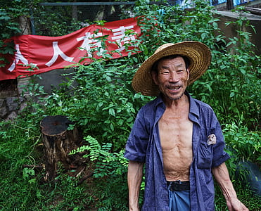 man wearing hat and unbuttoned shirt thumbnail