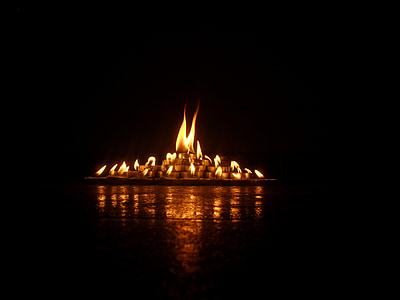 lighted candle inside dark room thumbnail
