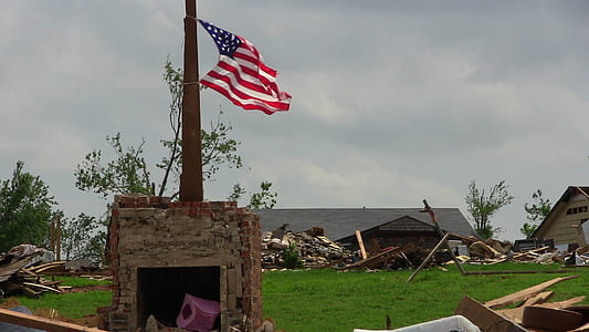 U.S. American flag on top of rock platform thumbnail