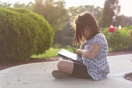 Girl Using Ipad Outdoors thumbnail