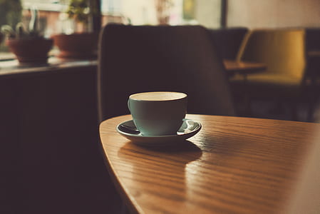 blue ceramic coffee cup on table near chair thumbnail