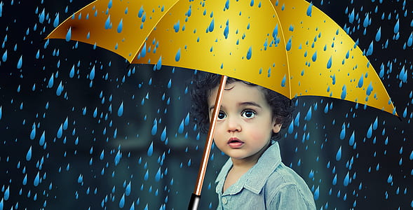 child holding yellow umbrella thumbnail