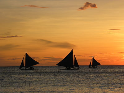 silhoutte of sailboats during sunset thumbnail