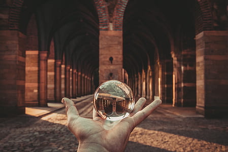 person holding water ball in front of concrete structure thumbnail