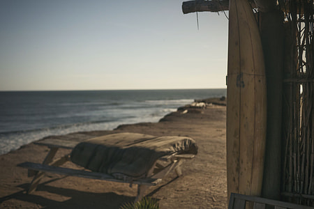 brown wooden picnic table nea seashore thumbnail