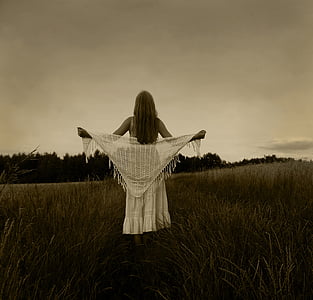 woman in white strapless dress holding scarf on green grass thumbnail