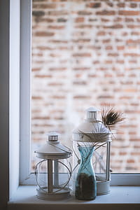 Two Clear Glass Lamp Lanterns Near Window thumbnail
