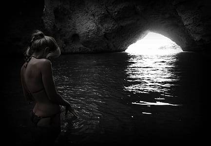 woman in black bikini on cave thumbnail