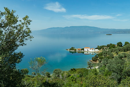 white concrete house surrounded with body of water thumbnail
