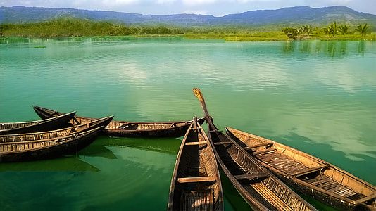 brown canoe on body of water thumbnail