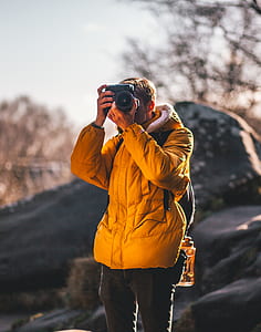 man taking photo using DSLR camera thumbnail
