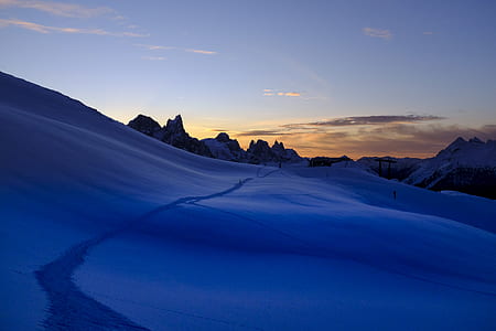 snowy mountains under cloudy sky thumbnail