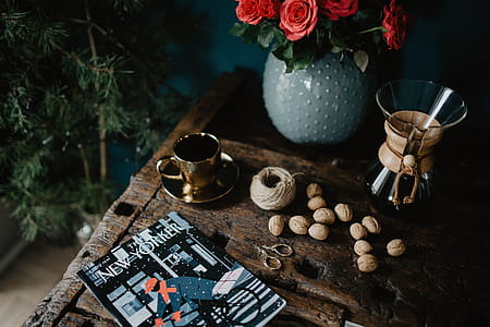 New Yorker, some nuts, watches, and other things on the old, wooden table thumbnail