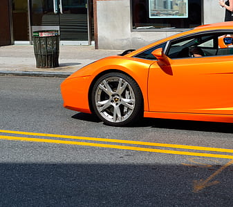 close-up photography of orange sports car thumbnail
