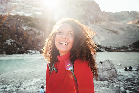 woman in red turtleneck top smiling thumbnail