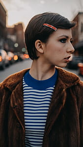 photo of side view woman standing surrounded by building with bokeh background thumbnail