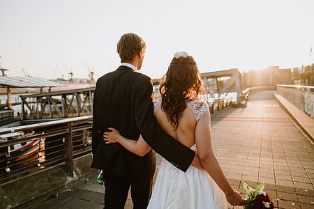 bride and groom walking while holding each other thumbnail