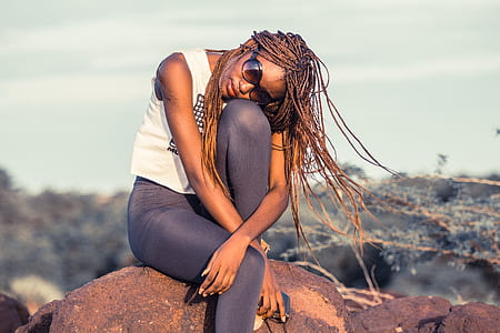 woman sitting on brown stone thumbnail