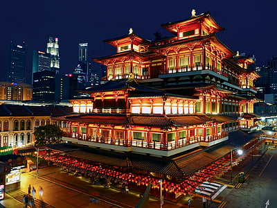 people near lighted building during night time thumbnail