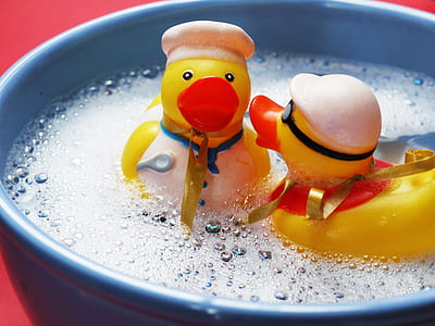 two yellow duckling plastic toys on bowl thumbnail