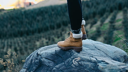 person standing on rock at daytime thumbnail