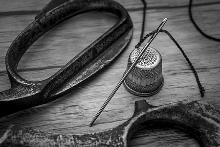 scissors, sewing needle, and thimble grayscale photo thumbnail