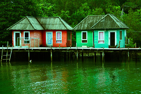red and green house on body of water thumbnail