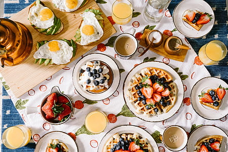fried egg and pancake with olive fruits and strawberries on top thumbnail