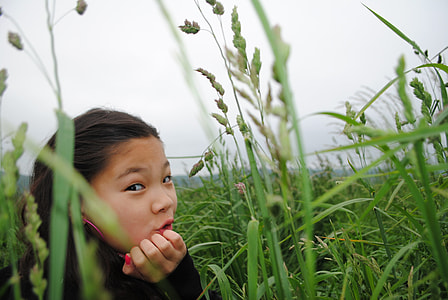 girl sitting near plants during daytime thumbnail