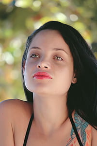 woman wearing black spaghetti strap top with blue butterfly tattoo thumbnail