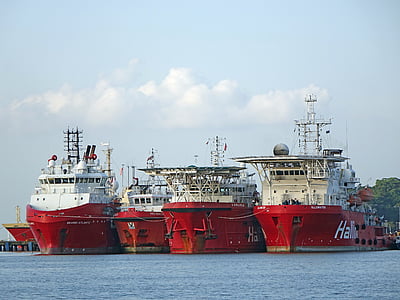 four red-and-white ships on body of water at daytime thumbnail