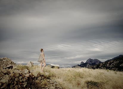 woman walking on grass field thumbnail