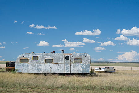 gray RV trailer on green grass thumbnail