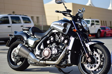 black Yamaha touring motorcycle parked far away from building thumbnail