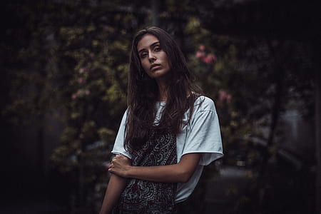 standing woman near flowers thumbnail