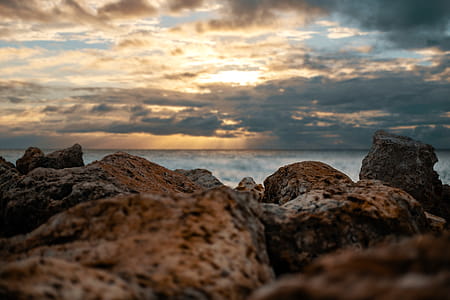 Brown Rocks Overlooking Body of Water thumbnail