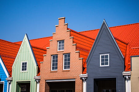 brown, black, and green house with red roof thumbnail