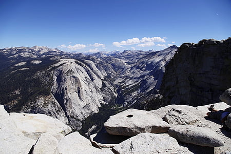 aerial photography of rocky mountain under blue and white cloudy skies at daytime thumbnail