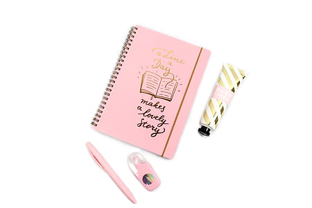 pink book beside pink click pen thumbnail