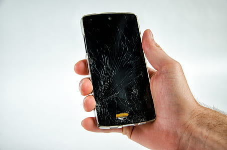person holding black smartphone displaying black screen thumbnail