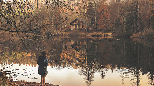 woman standing near tree and body of water thumbnail